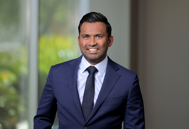 Professional picture of Dr. Itty in a suit