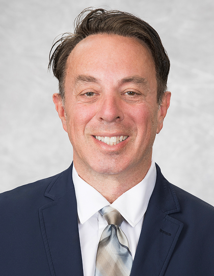 Headshot of David Carfagno, DO, in navy suit.