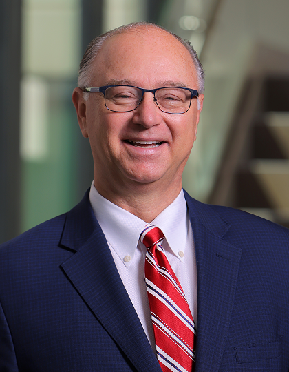 Headshot of Todd LaPorte with navy suit and red and white striped tie. 